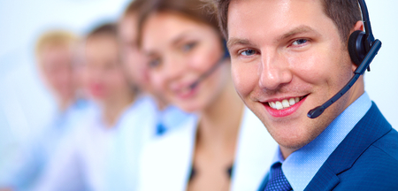 Attractive  positive young businesspeople and colleagues in a call center officeの写真素材