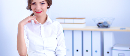 Attractive businesswoman sitting in the office.の写真素材