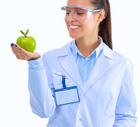 Smiling woman doctor with a green apple.の写真素材