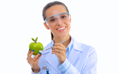Smiling woman doctor with a green apple.の写真素材