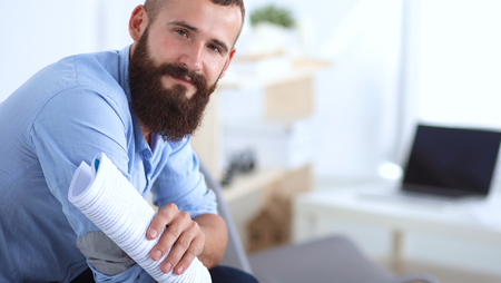 Young male office worker sitting on chair in office .の写真素材