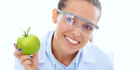 Smiling woman doctor with a green apple.の写真素材