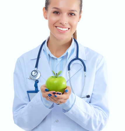 Smiling woman doctor with a green apple.の写真素材