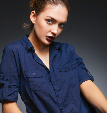 Portrait of beautiful young woman face. Isolated on black background.の写真素材