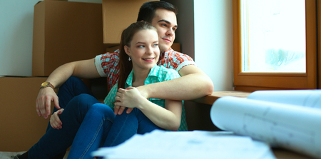 Portrait of young couple moving in new home.の写真素材