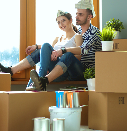Portrait of young couple moving in new home.の写真素材