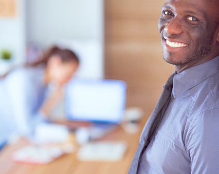 Attractive woman sitting at desk in office, working with laptop , having takeaway coffeeの写真素材