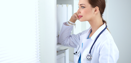 Woman doctor is standing near window .の写真素材