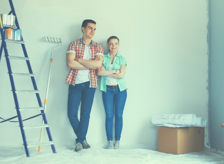 Portrait of young couple moving in new home.の写真素材