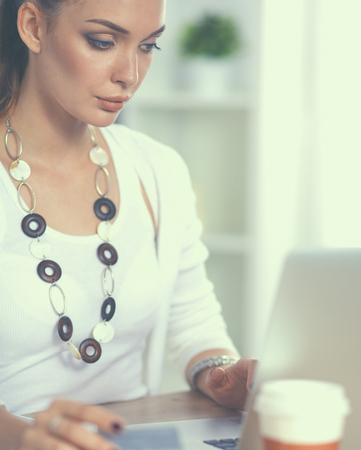 Businesswoman doing online shopping through laptop and credit cardの写真素材