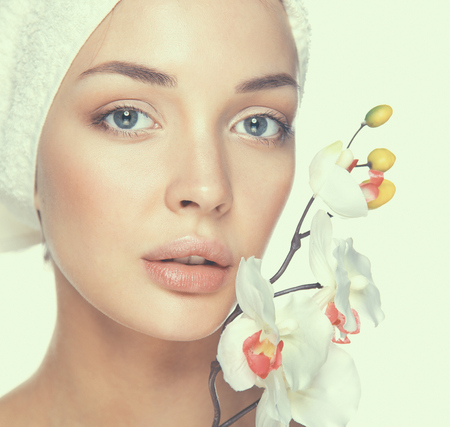 Woman in towel with orchid flowers .の写真素材