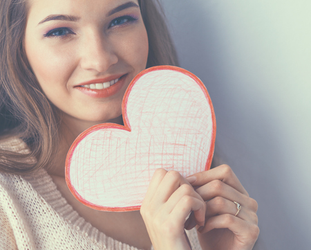 Young beautiful woman showing gift card. Valentine&amp;amp;amp;#39;s Dayの写真素材
