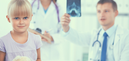 Female doctor examining child with stethoscope at surgery .の写真素材