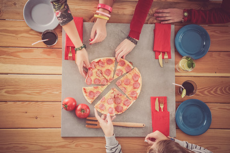 Group of people eating pizzaの写真素材