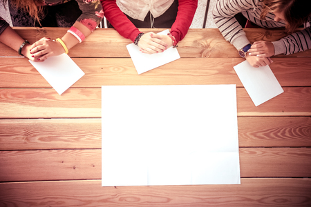Three women sitting at a desk, togetherの写真素材