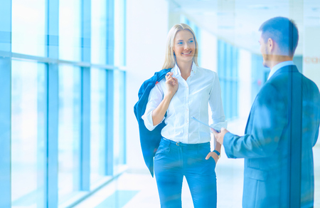 Businesspeople walking in the corridor of an business center.の写真素材