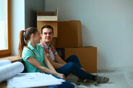 Young happy couple sitting floor in the new homeの写真素材