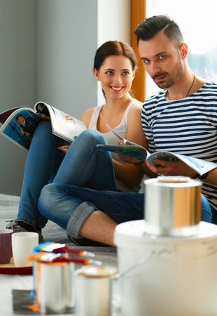 Young happy couple sitting floor in the new homeの写真素材