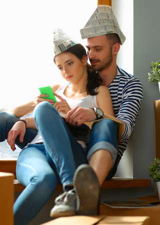 Young happy couple sitting in the new homeの写真素材