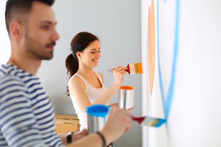 Young couple painting wall at homeの写真素材