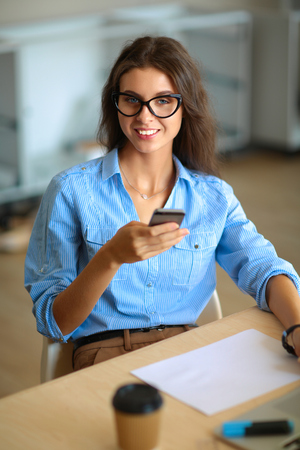 Young woman sitting at office table laptopの写真素材