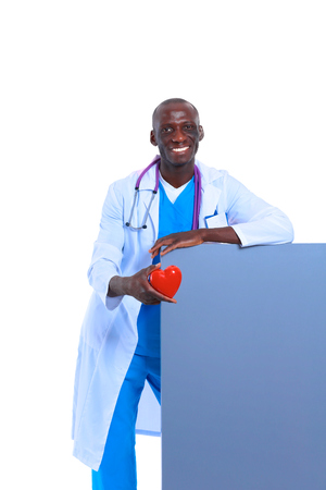 Male doctor with red heart and blank sign isolated on white backgroundの写真素材
