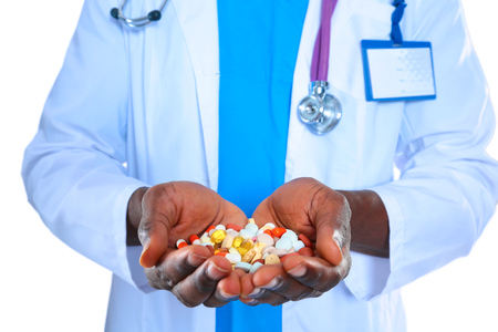 pill in a hand isolated on white backgroundの写真素材