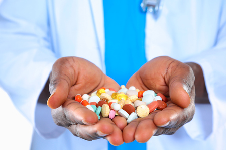 pill in a hand isolated on white backgroundの写真素材