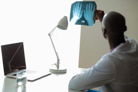 picture of male doctor looking at x-rayの写真素材