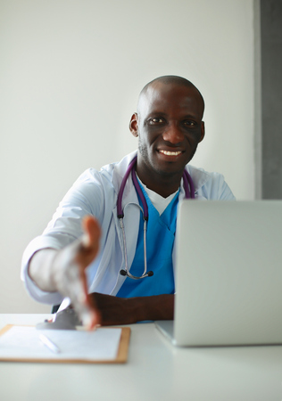 Male doctor handshake at his patient in medical officeの写真素材