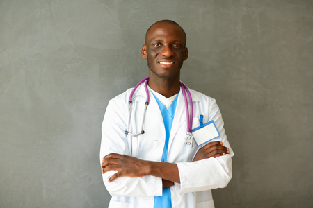 Doctor with arms folded in modern officeの写真素材