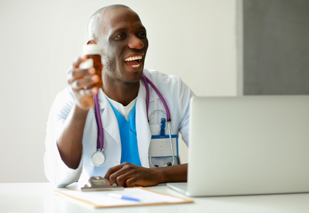 Close-up of male doctor giving jar of pills to patient.の写真素材