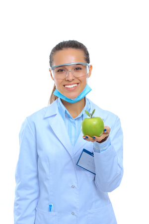 Smiling woman doctor with a green apple.の写真素材