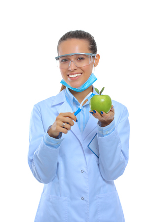 Dentist medical doctor woman hold green fresh apple in hand and tooth brushの写真素材