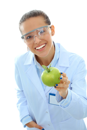 Smiling woman doctor with a green apple.の写真素材