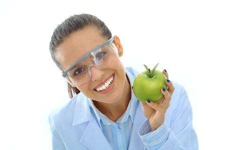 Smiling woman doctor with a green apple.の写真素材