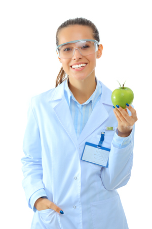 Smiling woman doctor with a green apple.の写真素材