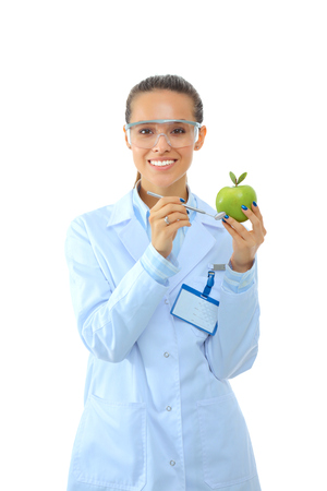 Dentist medical doctor woman hold green fresh apple in hand and mirrorの写真素材