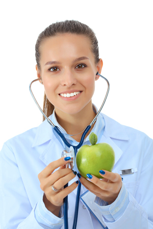 Medical doctor woman examining apple with stethoscopeの写真素材