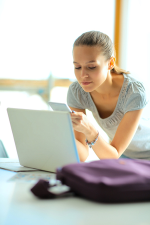 Woman use of mobile phone in universityの写真素材