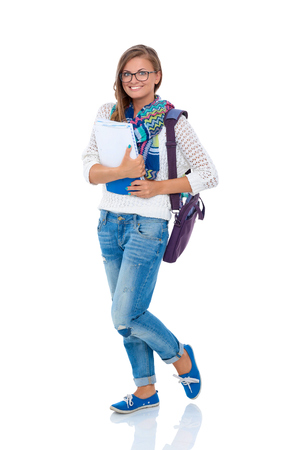 Portrait of young student woman holding exercise books.の写真素材