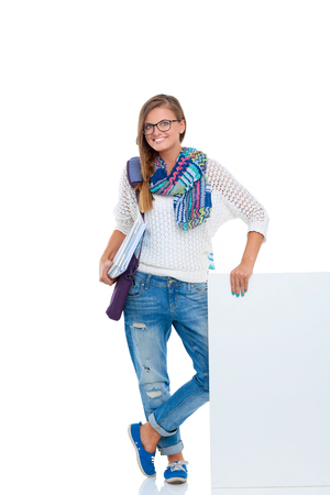 Beautiful student woman pointing on blank boardの写真素材