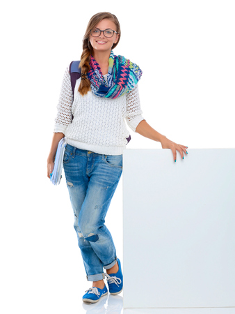 Beautiful student woman pointing on blank boardの写真素材