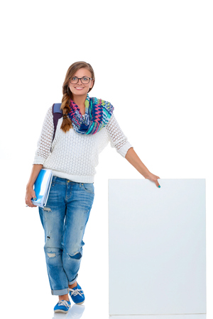Beautiful student woman pointing on blank boardの写真素材