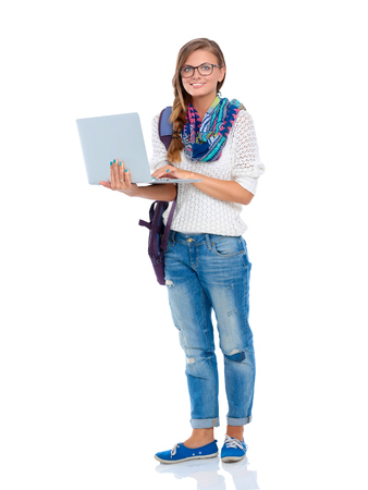 Smiling teenager with laptop on white backgroundの写真素材