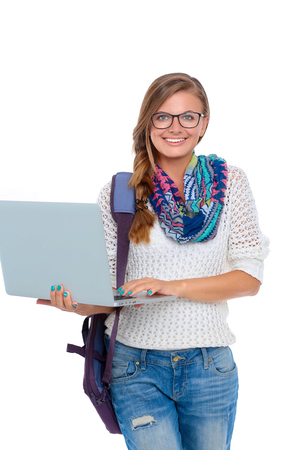Smiling teenager with laptop on white backgroundの写真素材