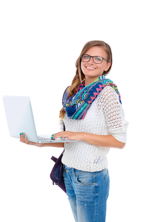 Smiling teenager with laptop on white backgroundの写真素材