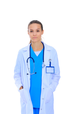 Beautiful young woman in white coat posing with hand in pocket.の写真素材