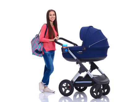 Full length portrait of a mother with a stroller, isolated on white backgroundの写真素材