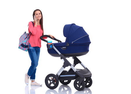 Full length portrait of a mother with a stroller, isolated on white backgroundの写真素材